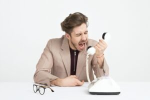 man yelling into a telephone